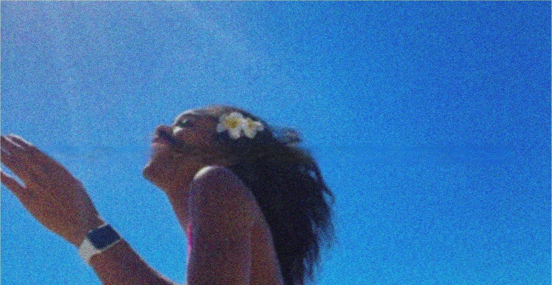 Mulher de rosto para o sol sob o céu azul de Trancoso